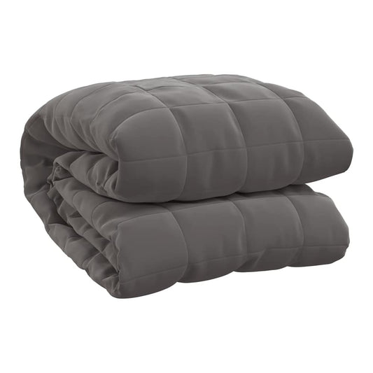 The grey weighted blanket folded neatly on a plain background