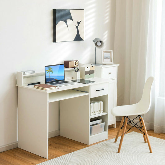 The office desk set up in a bright room with a laptop, lamp and chair for work and study