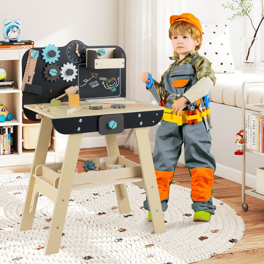 The play kitchen set standing in a room next to a child dressed in construction work clothes