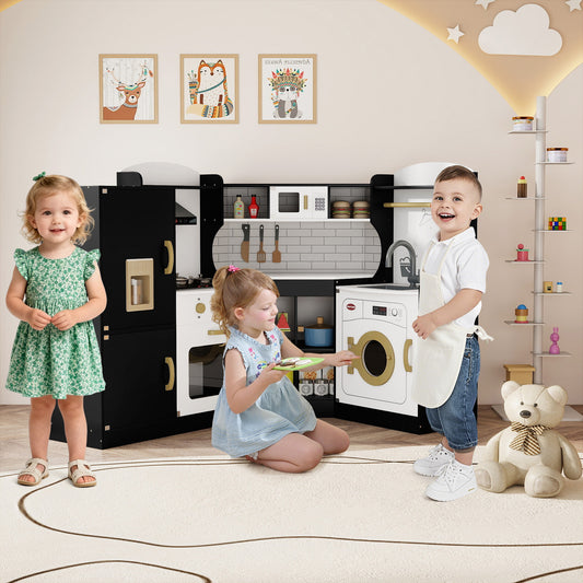 Two children playing with the black corner play kitchen set in a room with decorations