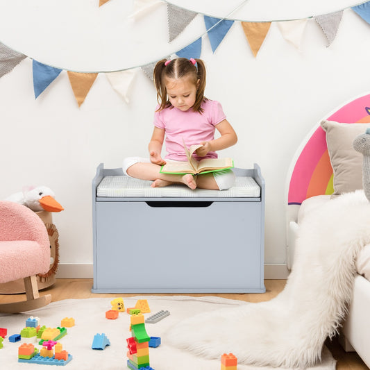 Grey kids storage bench with a girl reading on top surrounded by toys