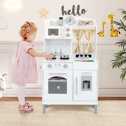 The play kitchen set standing in a child's bedroom with a young girl playing in front of it