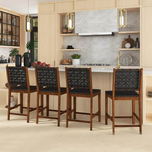 Four woven bar stools with black faux leather straps arranged at a kitchen island