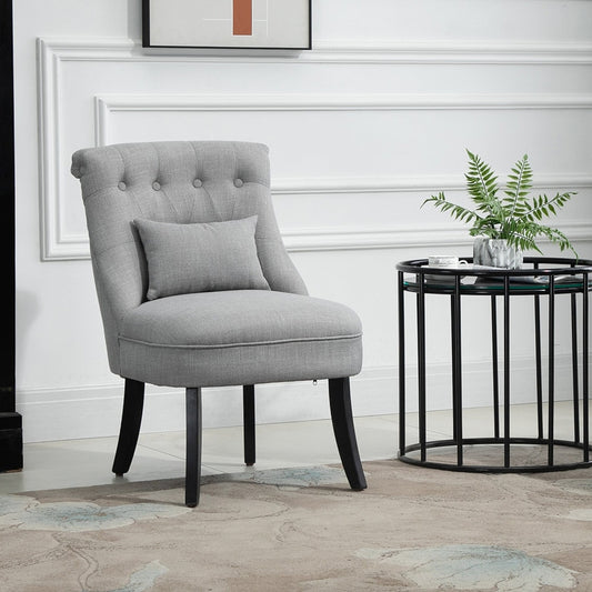 The grey fabric single sofa is placed next to a small round table in a room