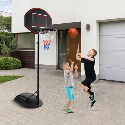 The sport equipment standing on a paved driveway with two boys playing basketball