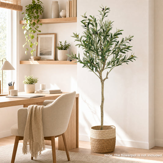Artificial olive tree in a bright room next to a desk and chair
