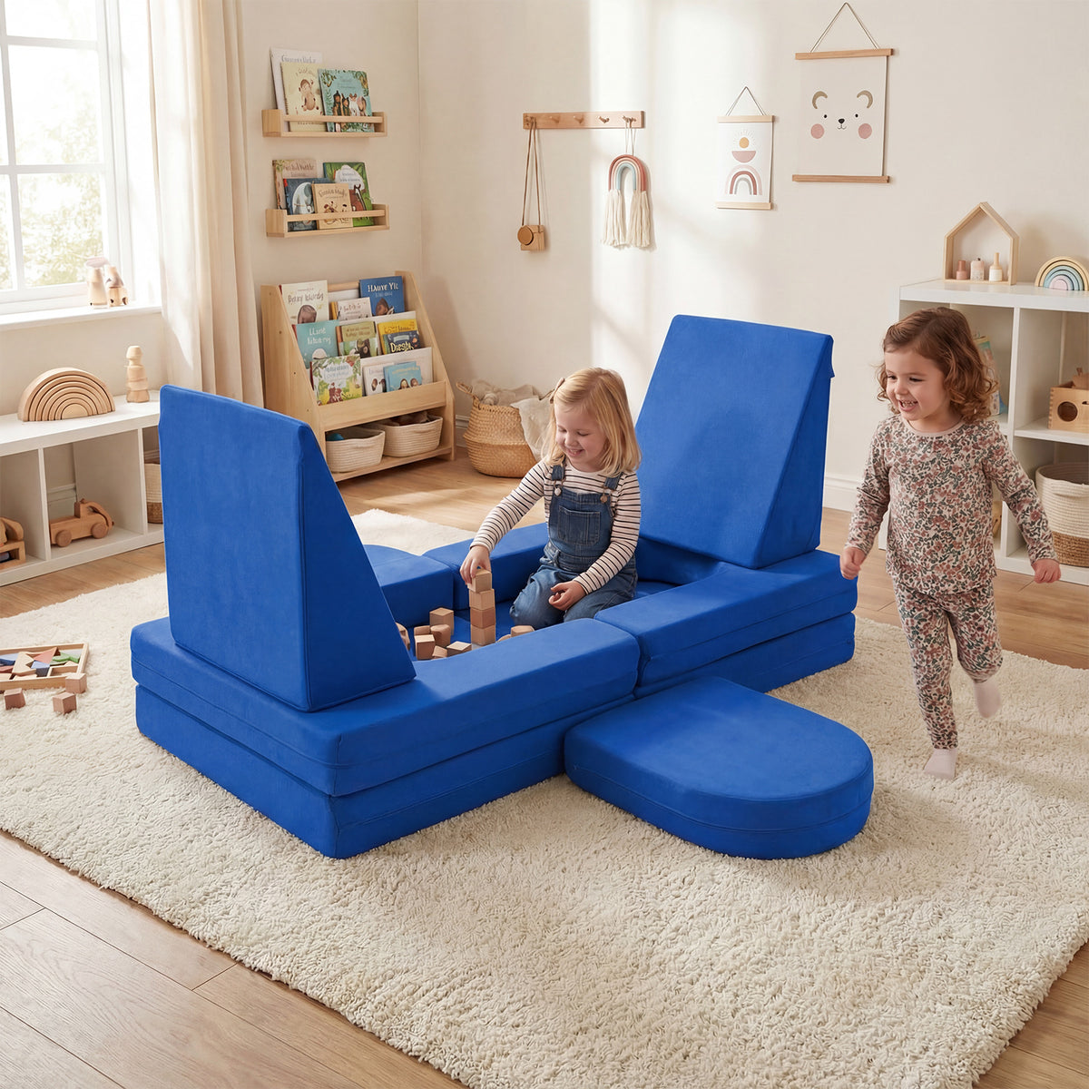 Navy blue soft play set in a living room with two children playing and building with wooden blocks