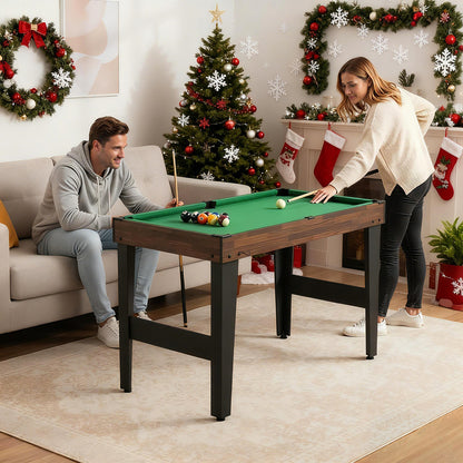 the game table set in a living room with people playing billiards during the festive season
