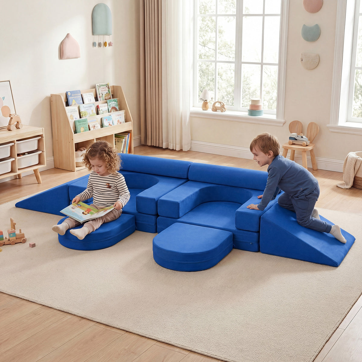 Navy blue soft play set with two children playing on it in a bright nursery room