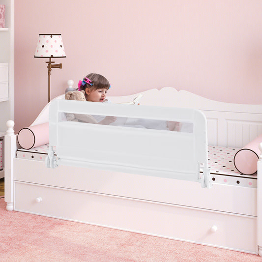 The bed rail in use on a child's bed with a girl looking over it