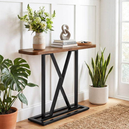The console table styled with plants and books in a hallway setting