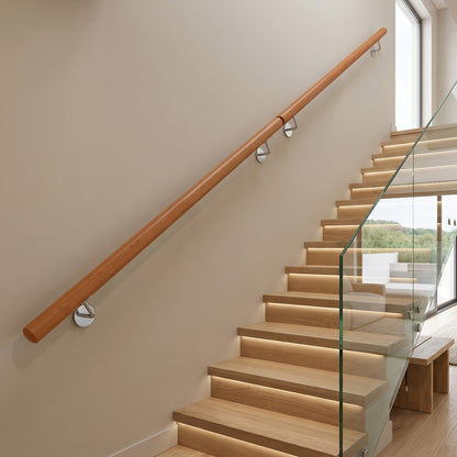 The indoor stair railing fitted along a lit staircase with a glass balustrade