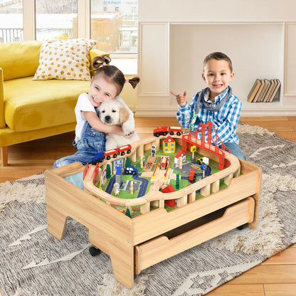 Children playing with the wooden train railway track set table in a living room
