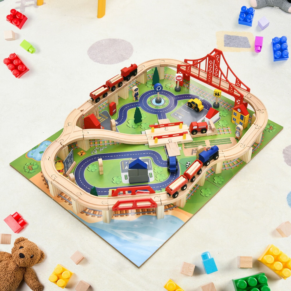 Top down view of the wooden train railway track set table with accessories scattered around