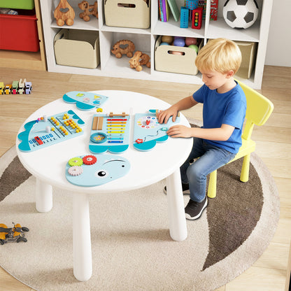 Boy playing with the dinosaur activity busy board panels on a table