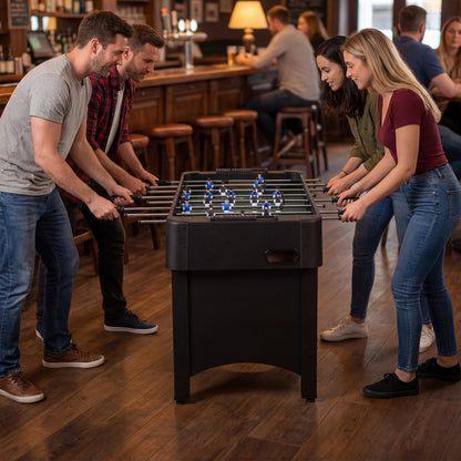 the soccer game table set up in a pub with people playing a match together