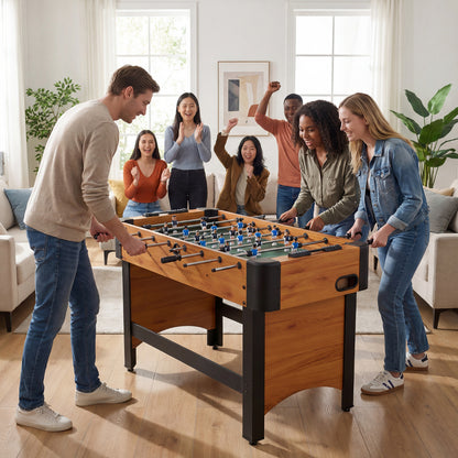 The soccer table being played by a group of friends in a bright living room setting