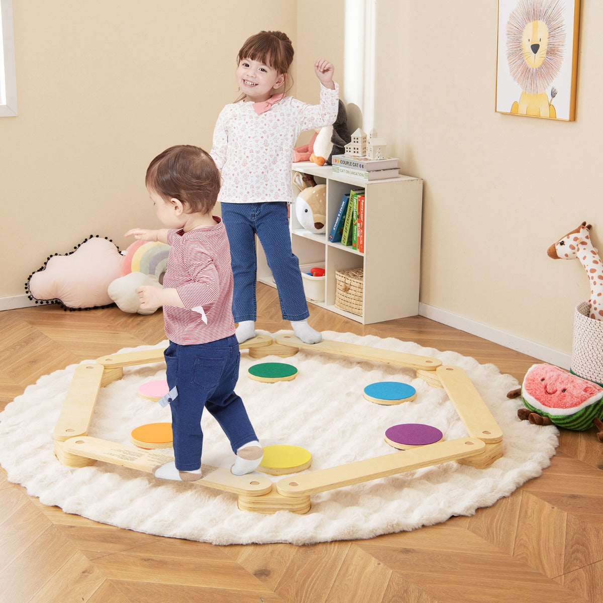 Two children playing on the wooden balance beam toy with colourful stepping stones on a rug