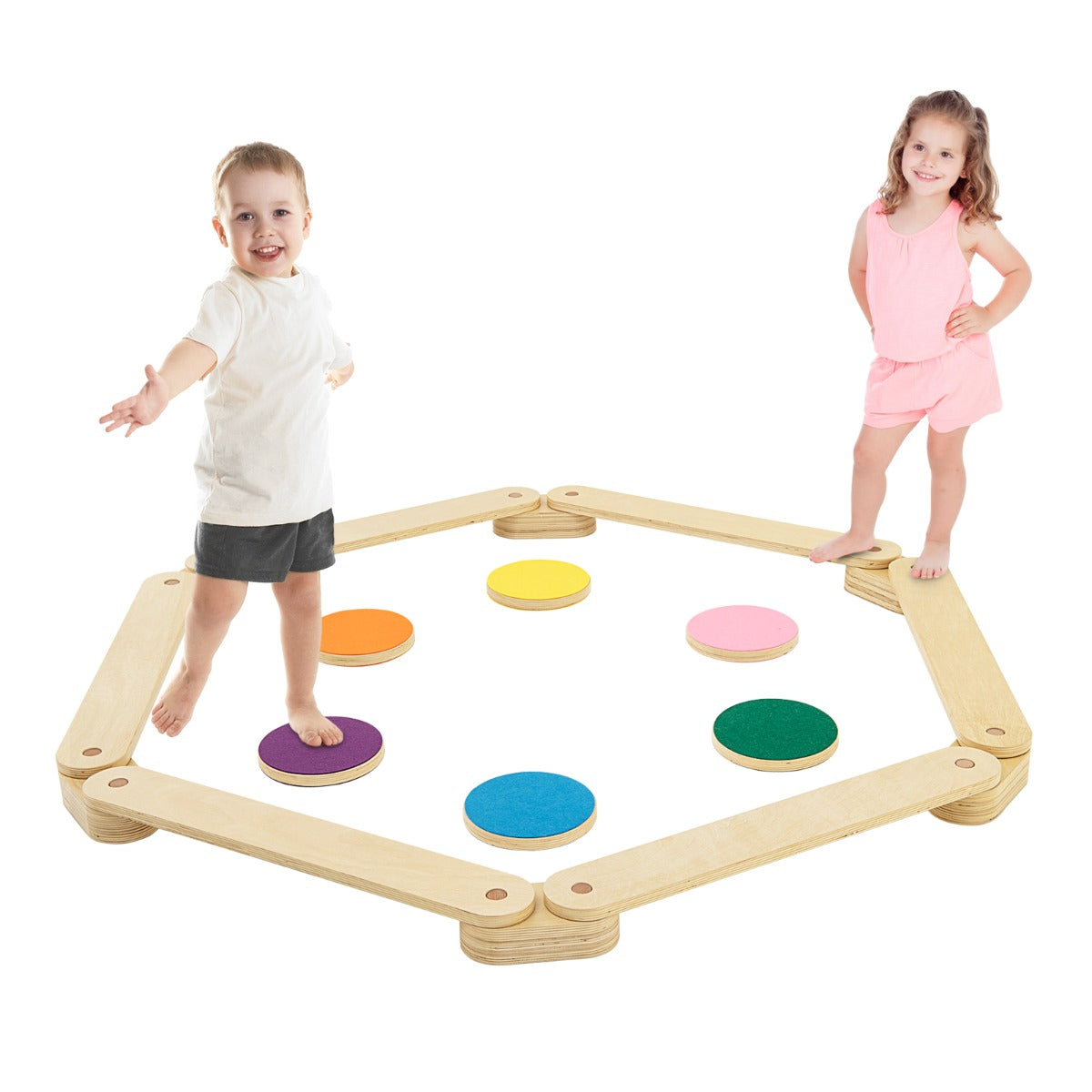 A baby and a young girl balancing on the wooden beam toy with colourful discs