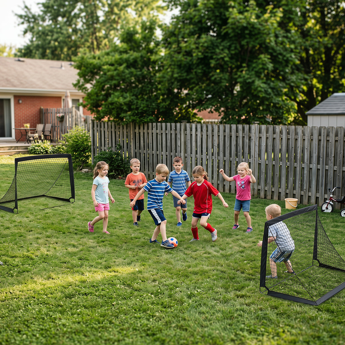 Several children playing football with two pop up goals in a garden