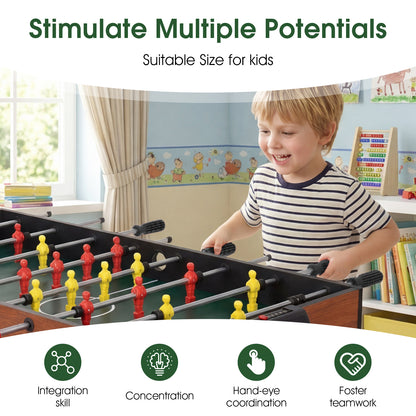 Close up of a young boy playing foosball on the multi games table