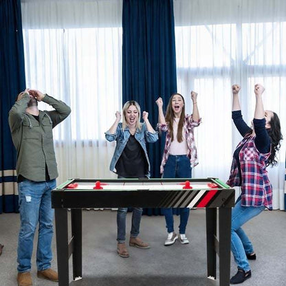 Friends celebrating around the 4-in-1 multi games table in a games room