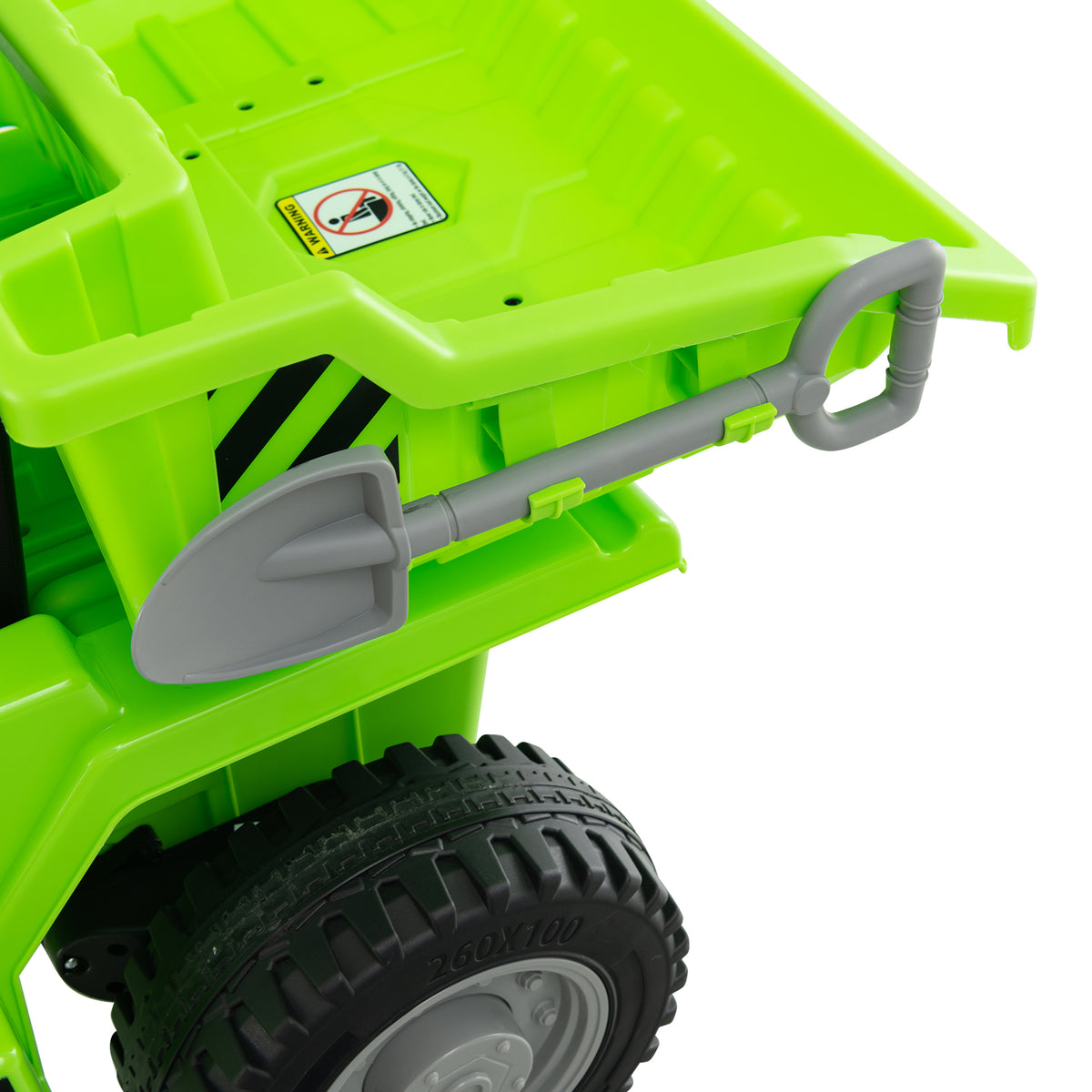 Close-up of the green kids electric dump truck's rear dump bed and attached shovel