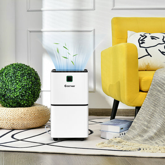 The portable electric dehumidifier in a bright living room with a yellow armchair