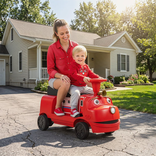 The kids electric train being ridden by a young child and an adult on a driveway outside a house