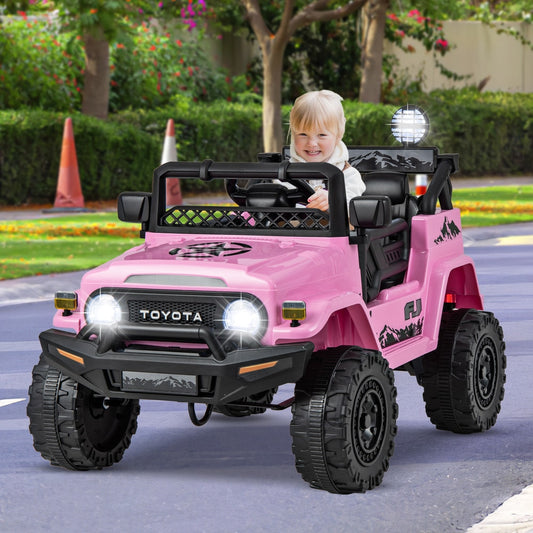 Child driving the pink kids electric car on a paved path with trees and houses in the background