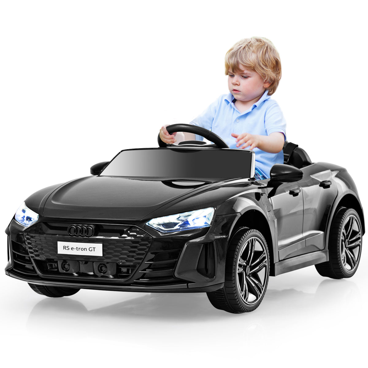 A child steers the black electric ride on car, demonstrating its use