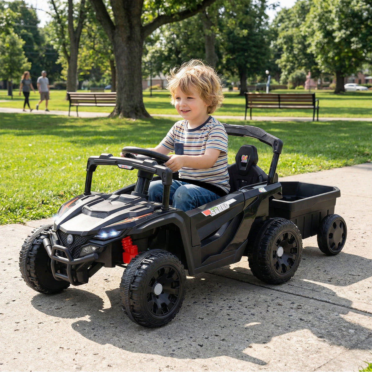 The kids electric tractor being driven by a young boy on a paved park path