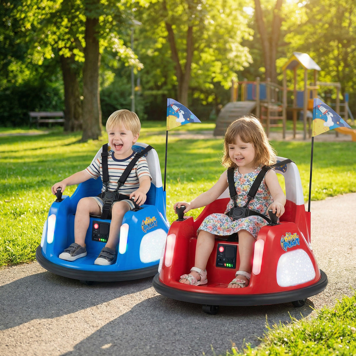12V Bumper Car, two kids electric cars, one red and one blue, being driven outdoors in a park