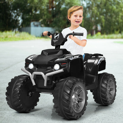 A young boy rides the black electric quad bike outdoors