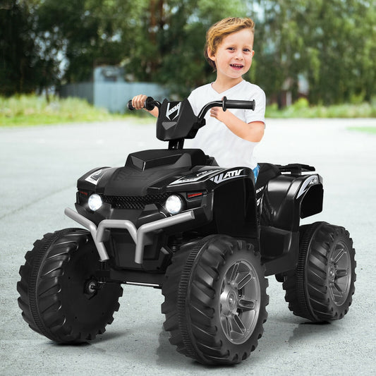 A young boy rides the black electric quad bike outdoors