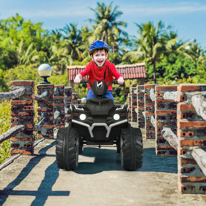 Child wearing a helmet on the black electric quad bike on a bridge