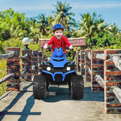 A happy child wearing a helmet riding the kids electric quad bike on a sunny outdoor path