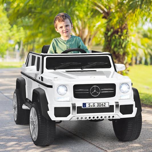 The kids electric car being driven by a young boy on a paved path