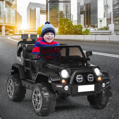 A happy child drives the black kids electric car on a road with buildings in the background