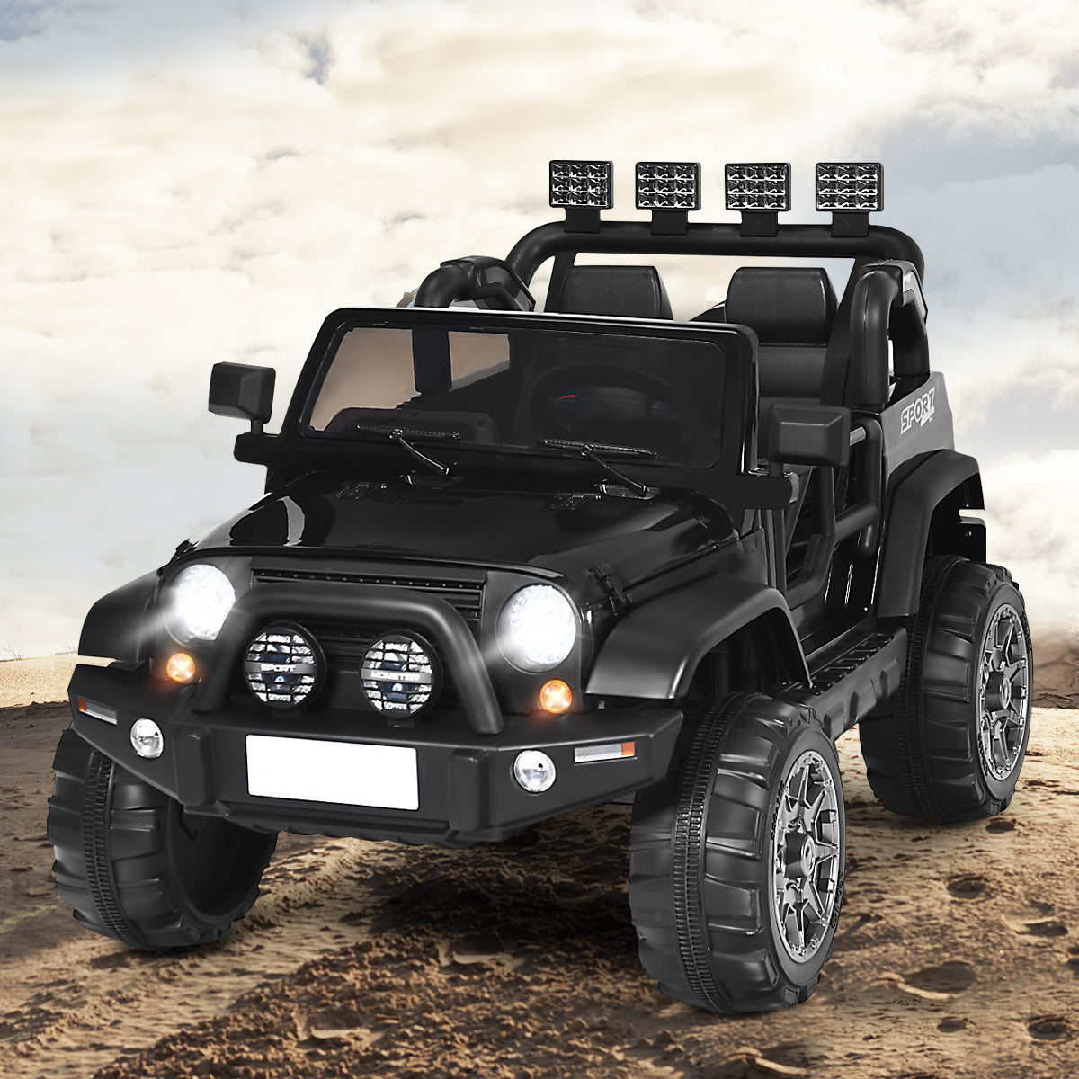 The black kids electric car parked on a sandy surface with a cloudy sky
