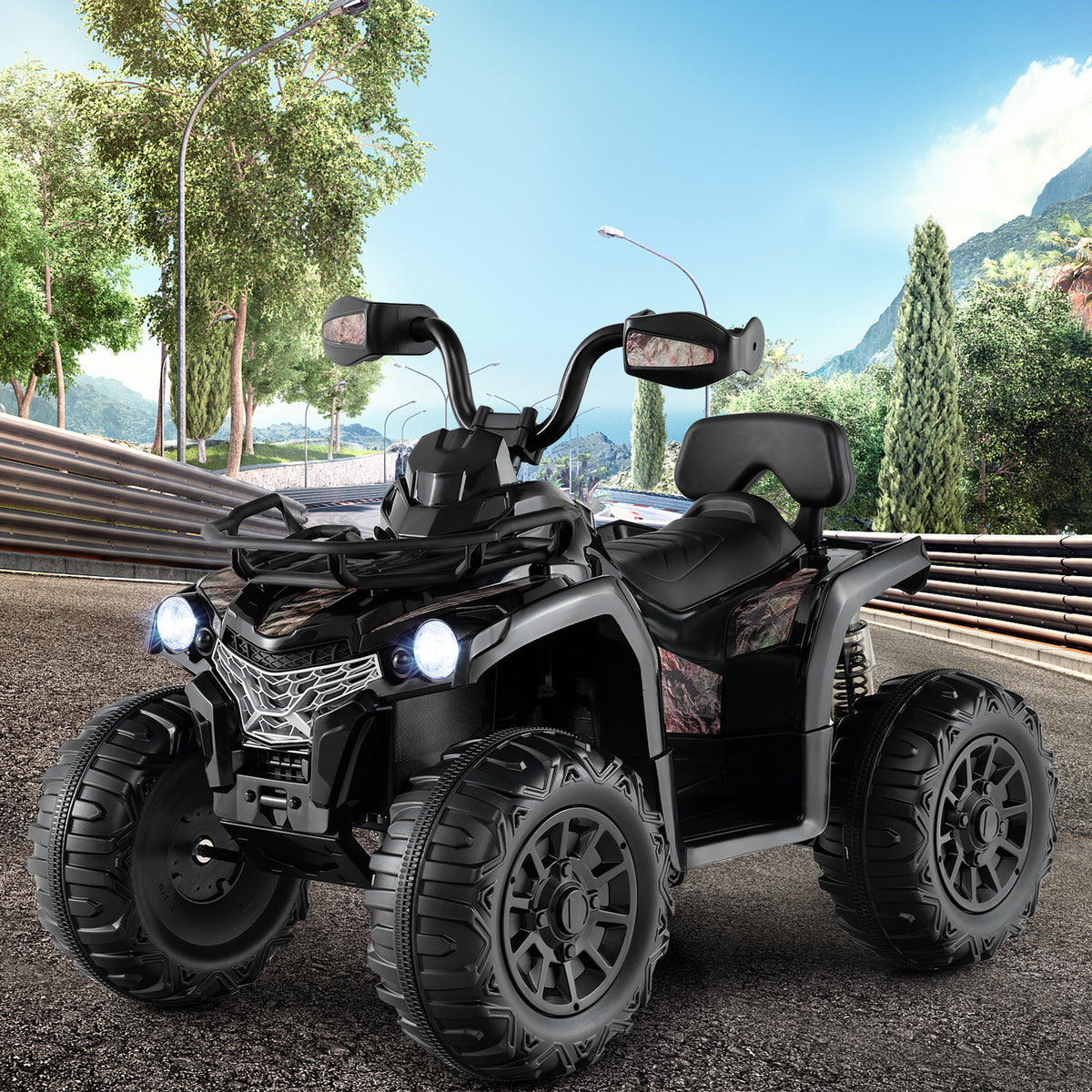 The black kids electric quad bike with lights on, shown outdoors on a track