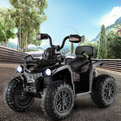 The black kids electric quad bike with lights on, shown outdoors on a track