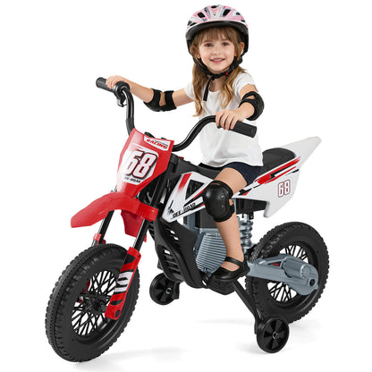 Girl on the red and white kids electric motorbike with training wheels, wearing safety gear