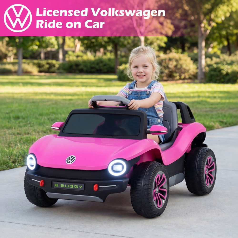A young girl sits in the pink electric ride on car, smiling at the camera