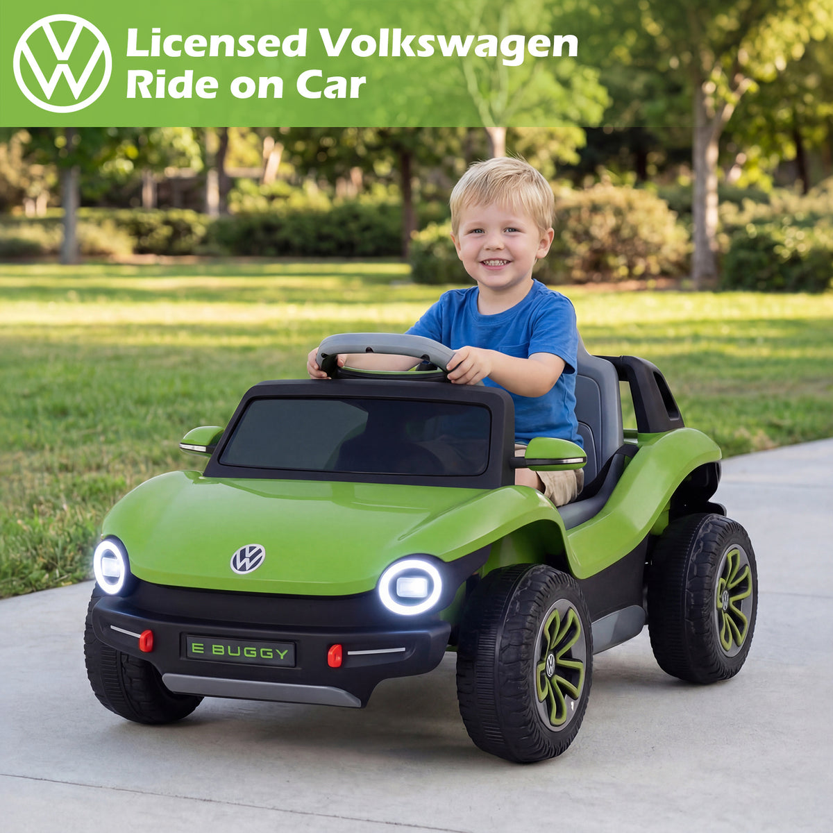 The kids electric car with a young boy sitting in the driver seat on a sunny day