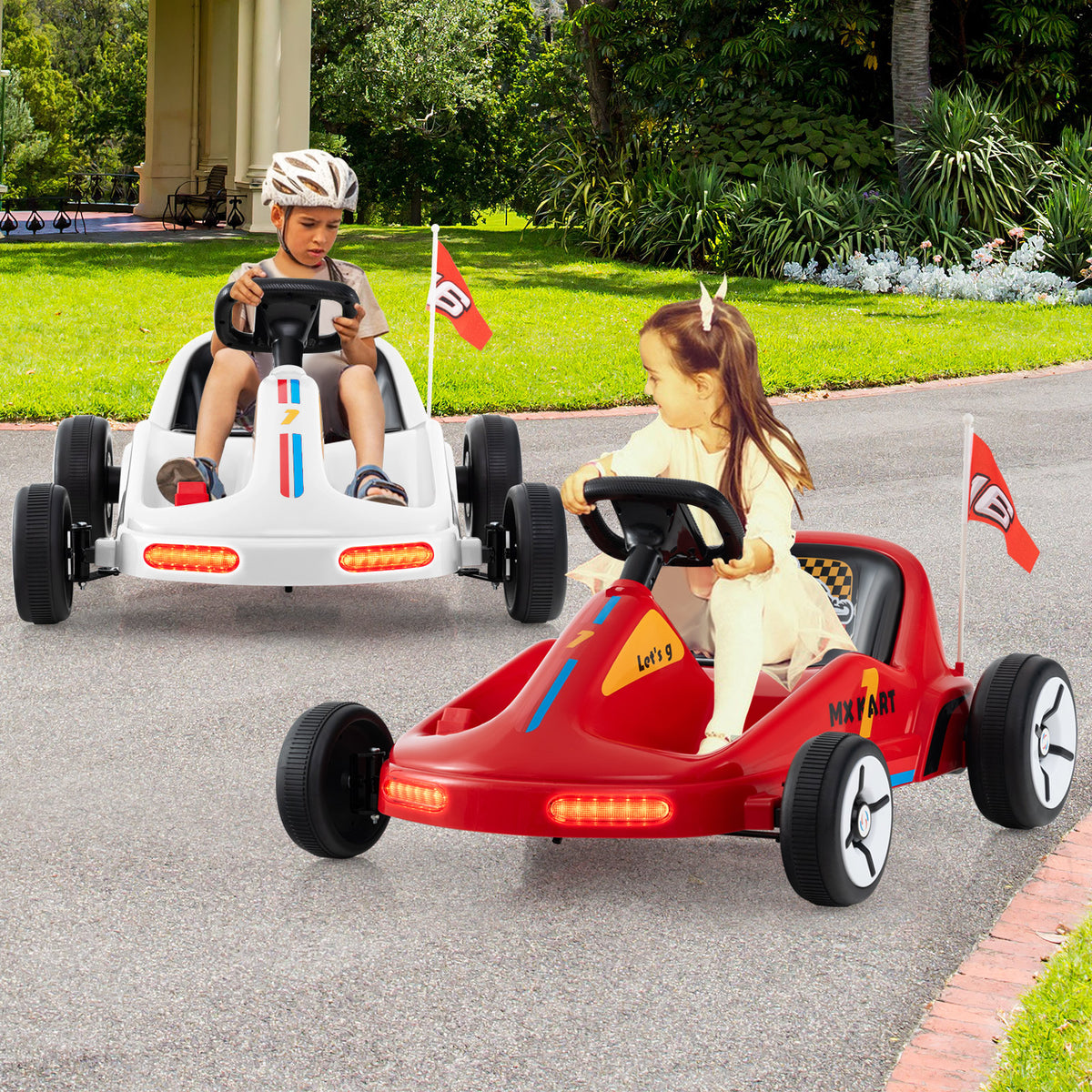 Two kids riding white and red electric go karts on a paved path