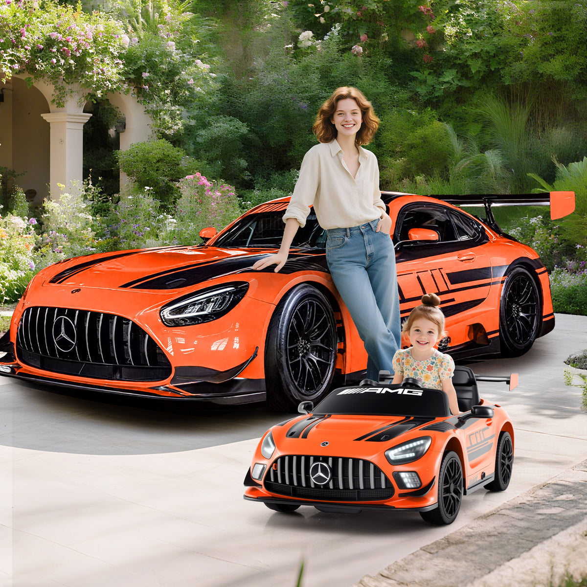 Woman and child with the orange kids electric car in a garden setting
