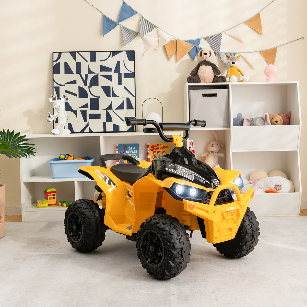 The yellow kids electric quad bike is parked indoors in a child's room