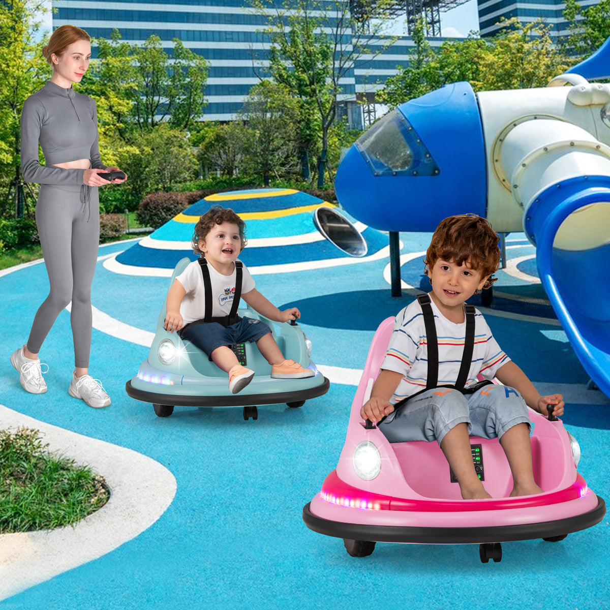A woman controlling a blue kids electric car while a child rides in a pink one