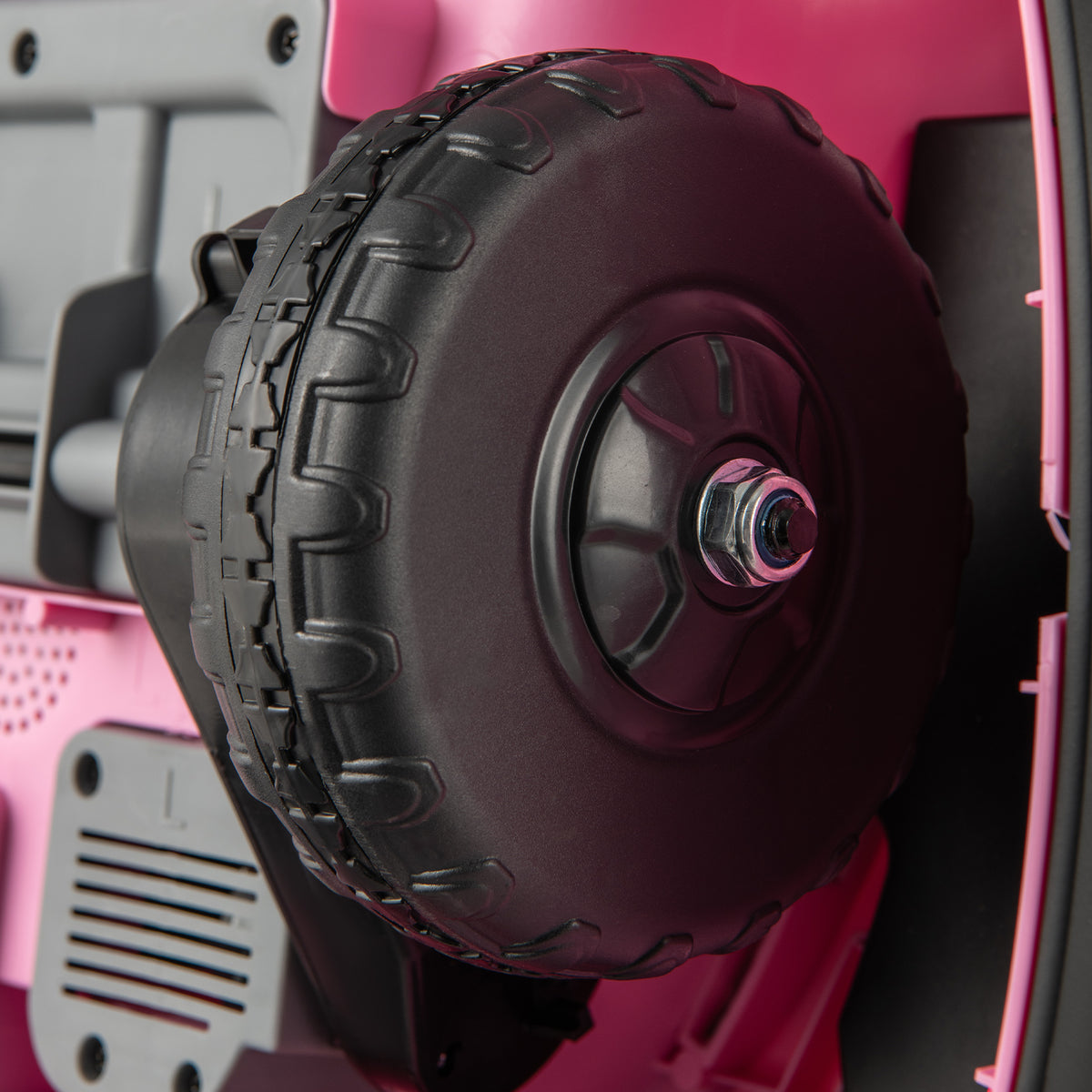 Close-up of the wheel on the pink kids electric bumper car